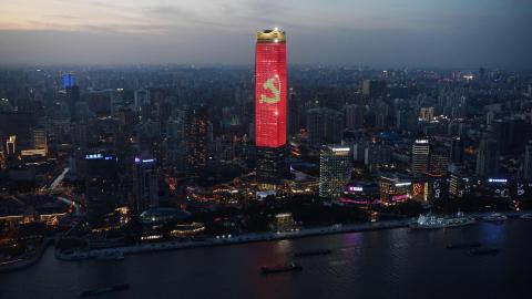 The Communist Party logo is seen on a skyscraper in Shanghai at dusk on August 31, 2021, part of celebrations marking the 100th anniversary of the founding of the Chinese Communist Party. (Photo by GREG BAKER / AFP) (Photo by GREG BAKER/AFP via Getty Images)