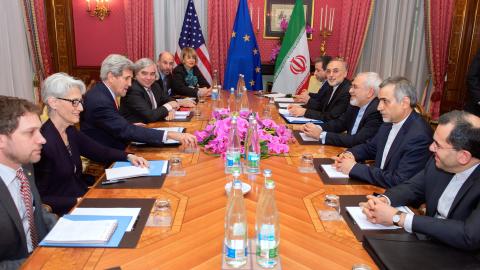 U.S. Secretary of State John Kerry -- flanked by Chief of Staff Jon Finer, Under Secretary of State for Political Affairs Wendy Sherman, U.S. Energy Secretary Dr. Ernest Moniz, National Security Council Senior Director for Iran, Iraq, Syria and the Gulf States Robert Malley, and European Union Deputy Secretary General Helga Schmid -- sits across from Iranian Foreign Minister Javad Zarif, Dr. Ali Akbar Salehi, the Vice President of Iran for Atomic Energy and President of the Atomic Energy Organization of Ira