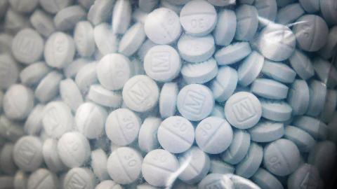 A bag of evidence containing the synthetic opioid fentanyl disguised as Oxycodone is shown during a 2020 news conference at the Fresno County Sheriff Office in Fresno, California. (Craig Kohlruss/The Fresno Bee/Tribune News Service via Getty Images)