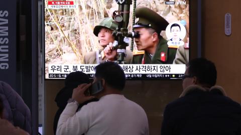 People watch a television screen showing a news broadcast with file footage of North Korea's artillery firing at a railway station on January 6, 2024, in Seoul, South Korea. (Chung Sung-Jun via Getty Images)