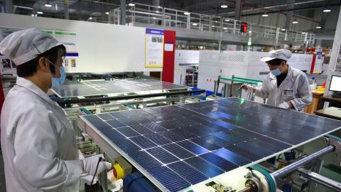 A worker is producing photovoltaic panel components at a workshop of a photovoltaic enterprise in Suqian, Jiangsu Province, China, on December 9, 2023. (Photo by Costfoto/NurPhoto via Getty Images)