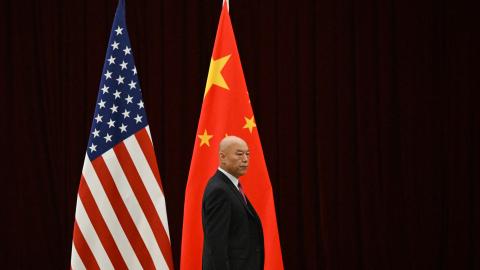 A man walks past China's and America's flags before a meeting between United States Treasury Secretary Janet Yellen and China's Vice Premier He Lifeng in Guangzhou, China, on April 5, 2024. (Pedro Pardo via Getty Images)