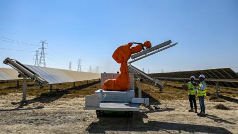 Workers install a solar panel at the Adani Group–owned Khavda Renewable Energy Park in Khavda on January 12, 2024. (Punit Paranjpe/AFP via Getty Images)