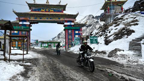 In this picture taken on April 5, 2023, motorbike riders cross into the snow laden Himalayan Sela pass in Tawang in northeast Indian state of Arunachal Pradesh. (Photo by Arun SANKAR / AFP) (Photo by ARUN SANKAR/AFP via Getty Images)