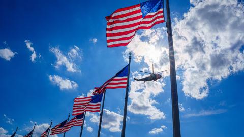 Marine One carrying Joe Biden flies past US Flags on April 18, 2024, in Washington, DC. (J. David Ake via Getty Images)