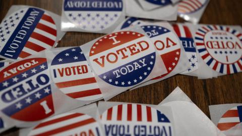 Stickers sit on a table during in-person absentee voting on November 1, 2024, in Little Chute, Wisconsin. (Scott Olson via Getty Images)