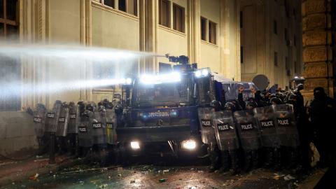 Riot police stand in position on the sidelines of a protest against the government's decision to delay EU membership talks, near the Parliament building in downtown Tbilisi on November 29, 2024. Georgian police fired water cannon and tear gas on demonstrators on the second day of protests against the government's decision to delay pursuing European Union accession. The Black Sea nation has been plunged into political crisis since contested parliamentary elections last month, with thousands rallying outside 