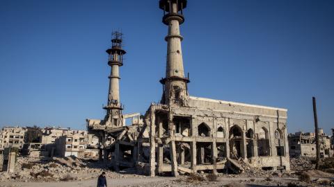 A man walks in front of the destroyed Sakina Shrine on December 25, 2024, in Damascus, Syria. (Chris McGrath via Getty Images)