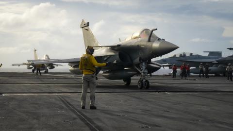A Sailor directs a Rafale Marine (F4) fighter jet, assigned to the aircraft carrier FS Charles De Gaulle on the flight deck of the aircraft carrier USS Carl Vinson in the Philippine Sea on February 12, 2025. (US Navy photo)