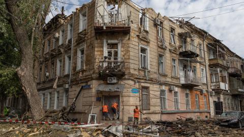 Communal workers clean debris next to a damaged residential building following a Russian drone attack in Odesa, Ukraine, on June 10, 2025. (Oleksandr Gimanov via Getty Images)