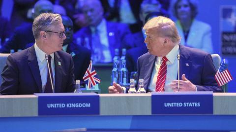 US President Donald Trump speaks to UK Prime Minister Keir Starmer at a North Atlantic Council plenary meeting during the NATO summit on June 25, 2025, in The Hague, Netherlands. (Kin Cheung via Getty Images)