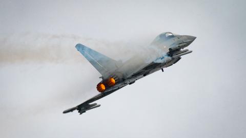 A Eurofighter Typhoon aircraft climbs with afterburners engaged during a flight demonstration at the Royal International Air Tattoo at RAF Fairford in England on July 19, 2025. (US Air Force photo)