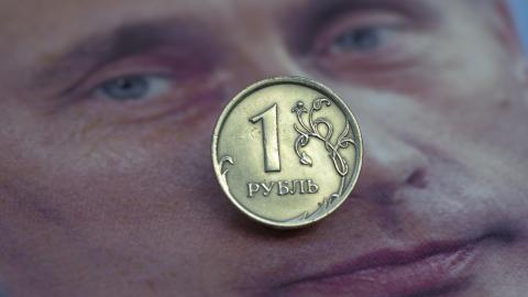 In this photo illustration, a one ruble coin on a portrait of Russian President Vladimir Putin is seen on July 14, 2025 in Bonn, Germany. Sanctions against Russia have caused the ruble to lose value. The Russian economy is struggling with the consequences of the war, which is costing the country enormous sums. (Photo illustration by Ulrich Baumgarten via Getty Images)
