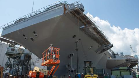 US Navy sailors and Newport News Shipbuilding workers reinstall the port side anchor onboard the Nimitz-class aircraft carrier USS John C. Stennis in Newport News, Virginia, on August 18, 2023. (US Navy)