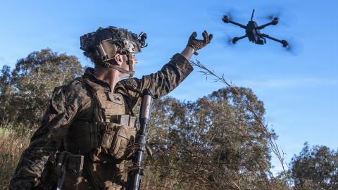 An intelligence specialist activates a Skydio X2 small unmanned aerial system to survey the defensive line for opposing forces during a simulated assault and seizure at Glen Airfield in Queensland, Australia, in July 2025. (US Marine Corps)