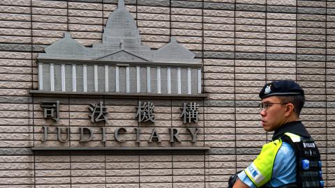 A police officer stands near the West Kowloon court where Hong Kong media mogul Jimmy Lai’s national security trial took place on August 28, 2025. (Getty Images)