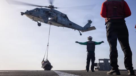 An MH-60S Sea Hawk helicopter, attached to Helicopter Sea Combat Squadron 9, delivers cargo to the flight deck of the world’s largest aircraft carrier, USS Gerald R. Ford (CVN 78), during a vertical replenishment with Henry J. Kaiser-class fleet replenishment oiler USNS Kanawha (T-AO 196), while underway during Operation Epic Fury, March 9, 2026. (U.S. Navy photo)