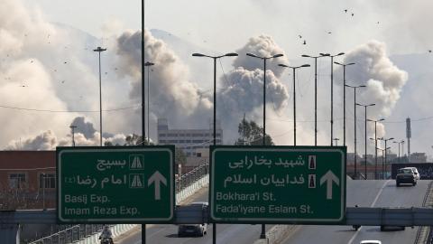 Vehicles drive along an expressway as smoke rises after an air strike in Tehran on March 5, 2026. (Getty Images)