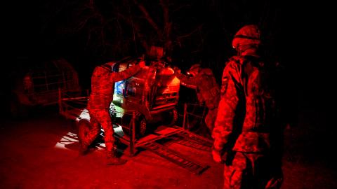 Fighters of the unmanned and ground robotic systems unit onto a platform for transport to a deployment point in Ukraine on March 10, 2026. (Getty Images)