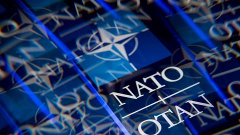 The logo of the North Atlantic Treaty Organization (NATO/OTAN) is displayed on a smartphone screen. (Getty Images)