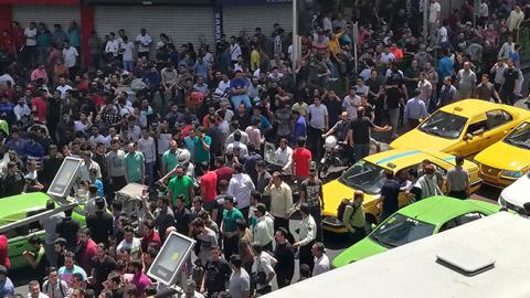 Iranian protesters shout slogans during a demonstration in central Tehran, June 25, 2018