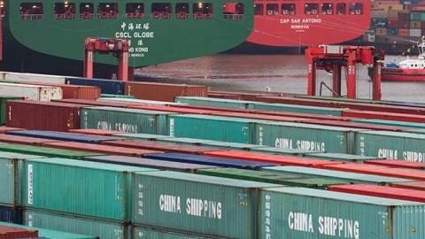 The container ship 'CSCL Globe' of shipping company China Shipping Group is accompanied by tugs during the docking maneuver at the container terminal Eurogate in Hamburg, Germany.