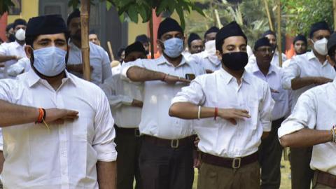 Rashtriya Swayamsevak Sangh (RSS) volunteers perform a salute towards the RSS flag during Shastra Puja ceremony (weapon worship) on the occasion of Vijayadashmi, on October 25, 2020, in Amritsar, India. (Getty Images)