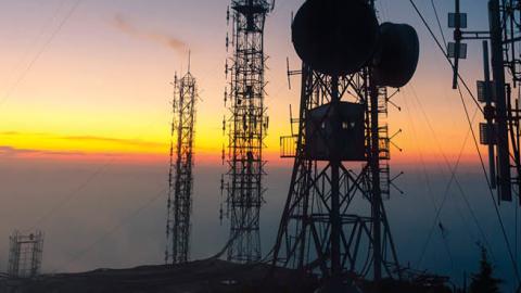 Signal receiving tower equipment at sunset. (Getty Images)