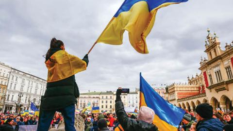 A protester is seen waving a Ukrainian flag during a demonstration in Krakow, Poland on February 27, 2022. (Getty Images)