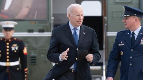 U.S. President Joe Biden is greeted by Colonel Matthew Jones, Commander, 89th Airlift Wing, at Joint Base Andrews in Maryland, on March 23, 2022. (Getty Images)