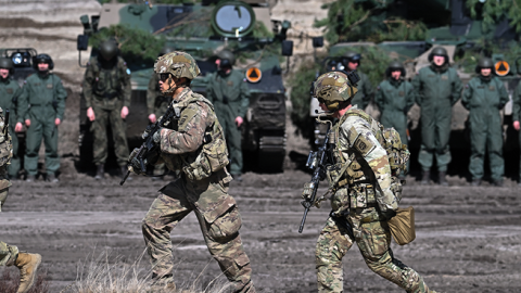 Troops from the Polish 18th Mechanised Division and the 82nd Airborne Division (USA) take part in tactical and fire training on April 8, 2022 in Nowa Deba, Poland. (Getty Images)