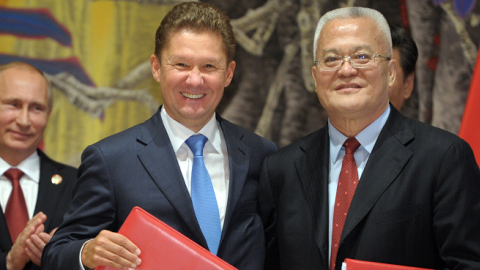 Russia's President Vladimir Putin (L) applauds during an agreement signing ceremony in Shanghai on May 21, 2014, with Gazprom CEO Alexei Miller (C) and Chinese state energy giant CNPC Chairman Zhou Jiping (R). (ALEXEY DRUZHININ/AFP/Getty Images)