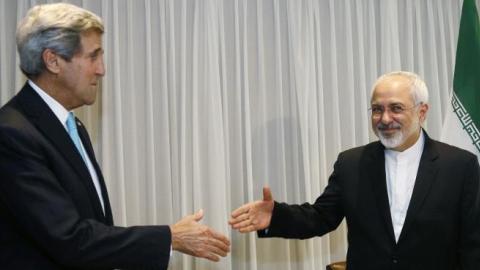 Iranian Foreign Minister Mohammad Javad Zarif (R) shakes hands on January 14, 2015 with US State Secretary John Kerry in Geneva. (RICK WILKING/AFP/Getty Images)