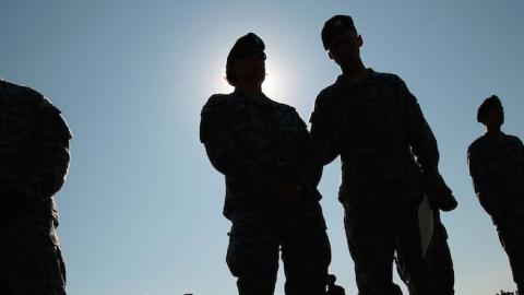 Soldiers in the 1st Infantry Division wait outside at a deployment ceremony as more soldiers at Fort Riley prepare to leave for another tour in Iraq August 13, 2009 at Fort Riley, Kansas. (Chris Hondros/Getty Images)