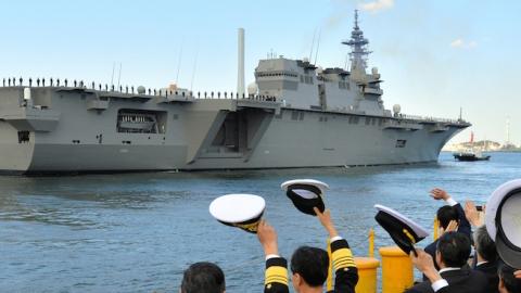 Japan Maritime Self-Defense Force members wave to the Izumo helicopter carrier on March 25, 2015 in Yokohama, Kanagawa, Japan. (The Asahi Shimbun via Getty Images)