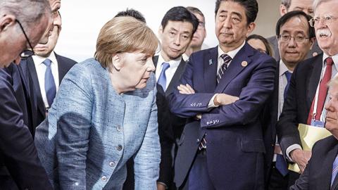 German Chancellor Angela Merkel deliberates with U.S. President Donald Trump on the sidelines of the official agenda on the second day of the G7 summit on June 9, 2018 in Charlevoix, Canada. (Jesco Denzel /Bundesregierung/Getty Images)