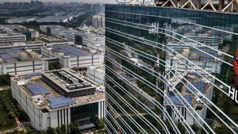 The Huawei logo is seen on the side of the main building at the company's production campus on April 25, 2019 in Dongguan, near Shenzhen, China.