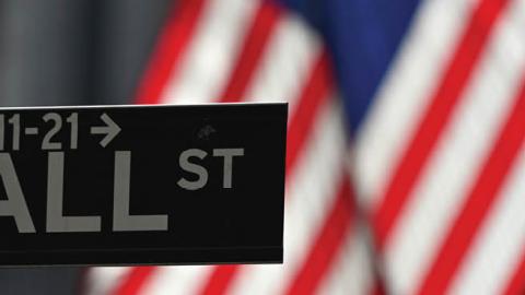 A Wall Street sign at the New York Stock Exchange (NYSE) on February 17, 2021 in New York City. (Photo by ANGELA WEISS/AFP via Getty Images)