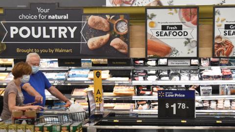 Customers wearing face masks shop at a Walmart supermarket amid novel coronavirus outbreak on July 15, 2020 in Washington, DC. (Photo by Sha Hanting/China News Service via Getty Images)