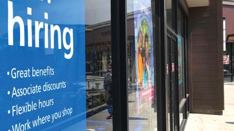 A pedestrian walks by a now hiring sign at Ross Dress For Less store on April 02, 2021 in San Rafael, California (Photo by Justin Sullivan/Getty Images)