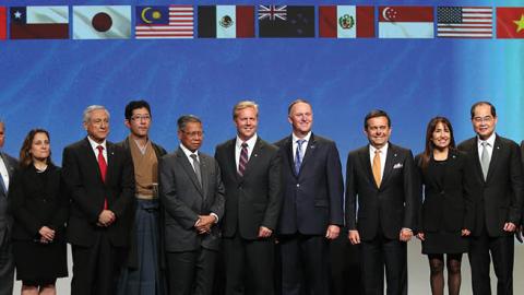 New Zealand Prime Minister John Key (6R) and Ministerial Representatives from 12 countries pose for a photo after signing the Trans-Pacific Partnership agreement in Auckland on February 4, 2016 (MICHAEL BRADLEY/AFP via Getty Images)