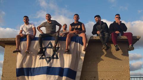 Israelis gather to watch the Iron Dome missile defence system launch to intercept rockets fire from the Gaza Strip on May 17, 2021 in Ashdod, Israel (Photo by Amir Levy/Getty Images)