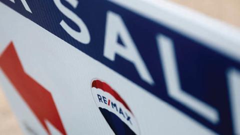 A reality sign in front of a for sale home in Annapolis, Maryland, on July 6, 2021. (Photo by JIM WATSON / AFP) 