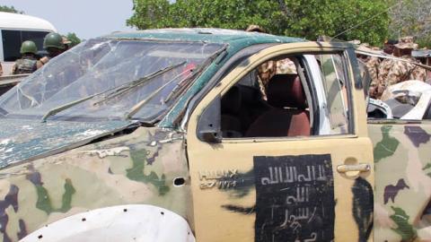 Soldiers stand beside damaged operational vehicles recovered from Boko Haram jihadists on display at the headquarters of the 120th Battalion in Goniri, Yobe State, in Nigeria's restive northeast on July 3, 2019. (Audu Marte/AFP via Getty Images)