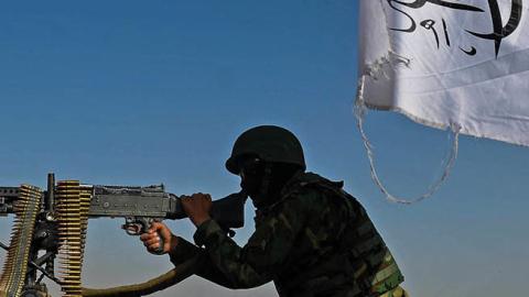 A Taliban fighter mans a machine gun mounted on a vehicle near the venue of an open-air pro-Taliban rally on the outskirts of Kabul on October 3, 2021 (Photo by HOSHANG HASHIMI/AFP via Getty Images)