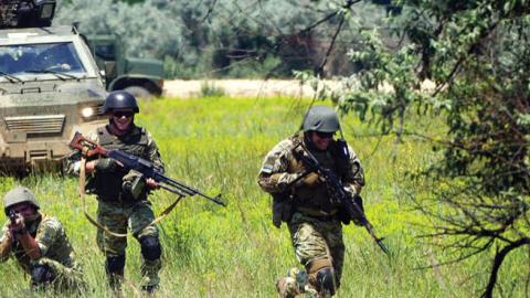 Servicemen conduct a land operation on the Oleshky Sands military training ground close to Crimea as part of the Sea Breeze 2021 maritime exercise held by NATO and its partner nations from June 28 through July 10. (Photo by Stringer\TASS via Getty Images)