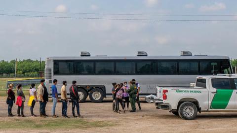 Migrants wait in line to be processed after crossing the Rio Grande into the U.S. on May 03, 2022 in La Joya, Texas. (Photo by Brandon Bell/Getty Images)