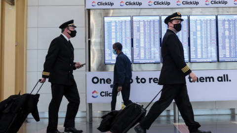 Airline pilots walk through the Ronald Reagan Washington National Airport on December 27, 2021, in Arlington, Virginia. (Anna Moneymaker/Getty Images)