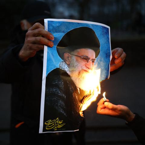Protesters burn an image of Ayatollah Ali Khamenei during a gathering outside the Iranian embassy in central London on January 12, 2026. (Getty Images)