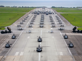 Edited version of US Air Force, US Navy, and US Marine Corps aircraft along with US Army Patriot missile batteries line up on the runway for an elephant walk during a routine operational readiness